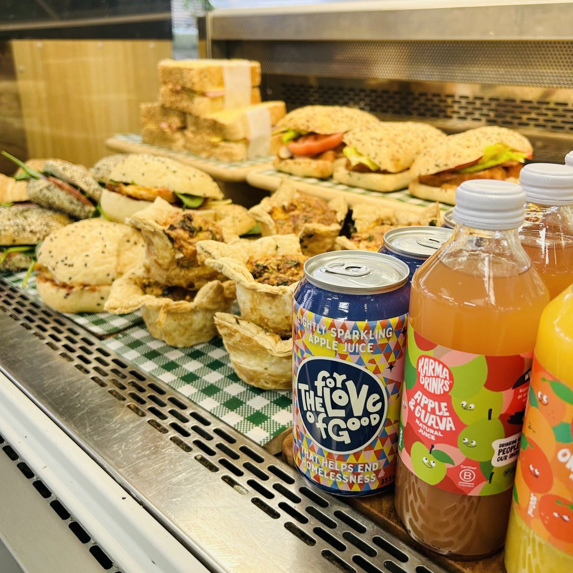 Display case with sandwiches and juice drinks in a store setting